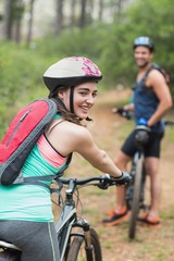 Wall Mural - Happy female biker with man on dirt road