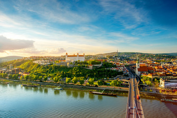 Canvas Print - Bratislava aerial cityscape view on the old town with Saint Martin's cathedral, castle hill and Danube river on the sunset in Slovakia. Wide angle view with copy space