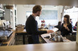 © chickenstockimages - Female Customer Paying In Coffee Shop