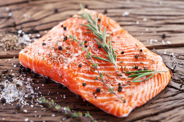 Wall Mural - Salmon filet on a wooden carving board.