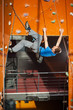 © anatoliy_gleb - Athletic male climber with special equipment climbs on an indoor rock-climbing wall