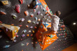 © anatoliy_gleb - Free climber young man climbing artificial boulder in gym, without special equipment