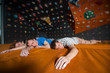 © anatoliy_gleb - Three tired guys with closed eyes lying on the orange mat near rock wall indoors. Bouldering