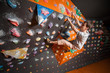 © anatoliy_gleb - Free climber young guy climbing artificial boulder in gym with climbing shoes