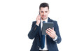 © Catalin Pop - Confident businessman with modern tablet is talking on cellphone