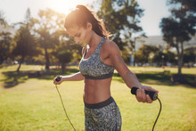 Fit Young Woman With Jump Rope In A Park