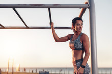 Muscular Woman Standing By Monkey Bars