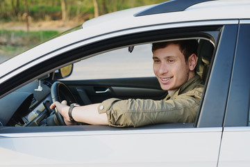 Handsome man in white car