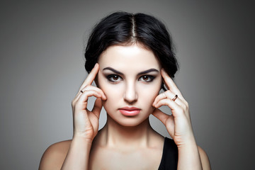 Portrait of beautiful female model on gray background