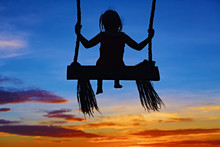 Black Silhouette Of Baby Girl Flying High With Fun On Rope Swing On Blue Orange Sunset Sky Background. Travel Lifestyle, People Beach Activity On Summer Family Vacation With Child In Tropical Island.
