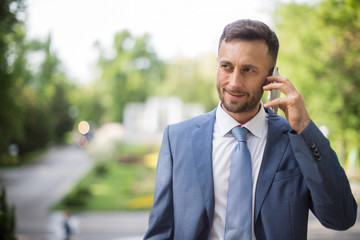 businessman wearing modern suit, blurred background with copy sp