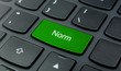 Business Concept: Close-up the Norm button on the keyboard and have Lime, Green color button isolate black keyboard