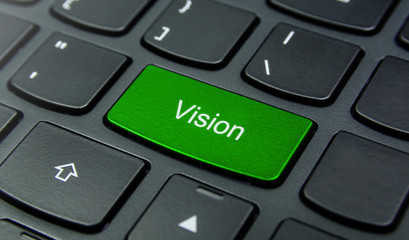 Business Concept: Close-up the Vision button on the keyboard and have Lime, Green color button isolate black keyboard