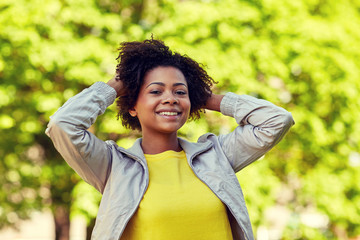 Wall Mural - happy african american young woman in summer park