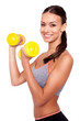 Making good progress. Portrait of a smiling young woman lifting weights against white isolated background.