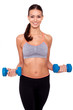 Keeping my body toned. Shot of a beautiful and sporty young woman lifting up weights against white isolated background.
