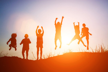 silhouette of children jump gladness happy time