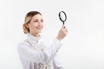 Young woman with a magnifying glass