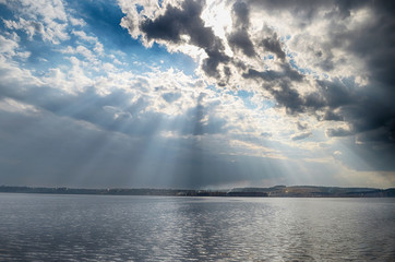Wall Mural - rays of sun shining through the clouds.