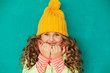 eautiful little lady wearing yellow woolen cap and scarf