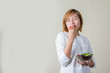 © Johnstocker - beautiful woman standing holding bowl of salad eating some veget