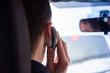 © ifeelstock - unrecognizable driver using phone while driving the car