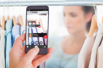 Poster - composite image of female hand holding a smartphone