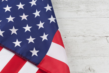 Usa flag folded on white rustic wooden table. Horizontal image with copy space