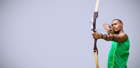 Poster - composite image of front view of sportsman practising archery