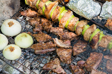 Fresh meat and vegetables preparing on grill.