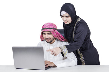 Wall Mural - Arabian couple working with laptop