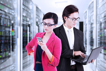 Entrepreneurs working in the data center room