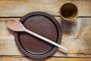 medieval pottery dishes and spoon on a old wooden table