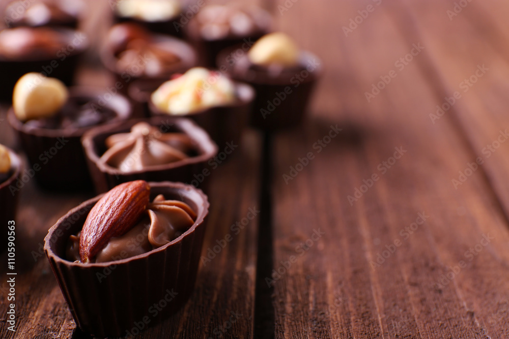 Chocolate sweets on wooden background