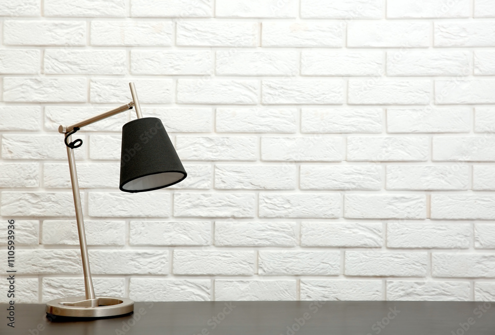 Modern lamp on the desk on white wall background