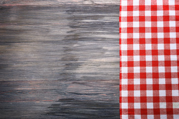 Wall Mural - Checkered napkin on wooden background