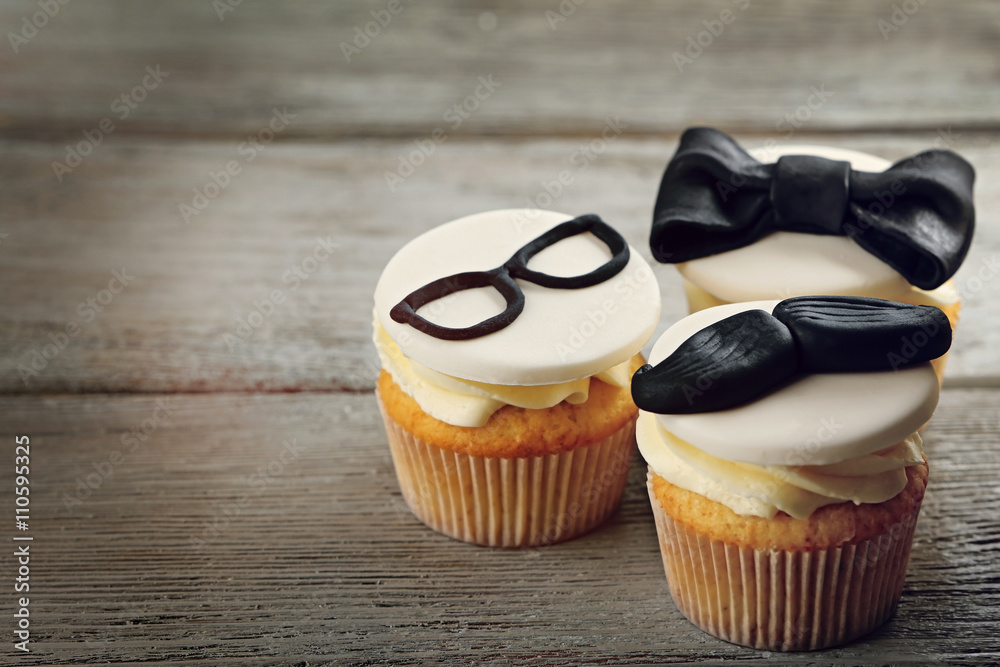 Delicious creative cupcakes on wooden table