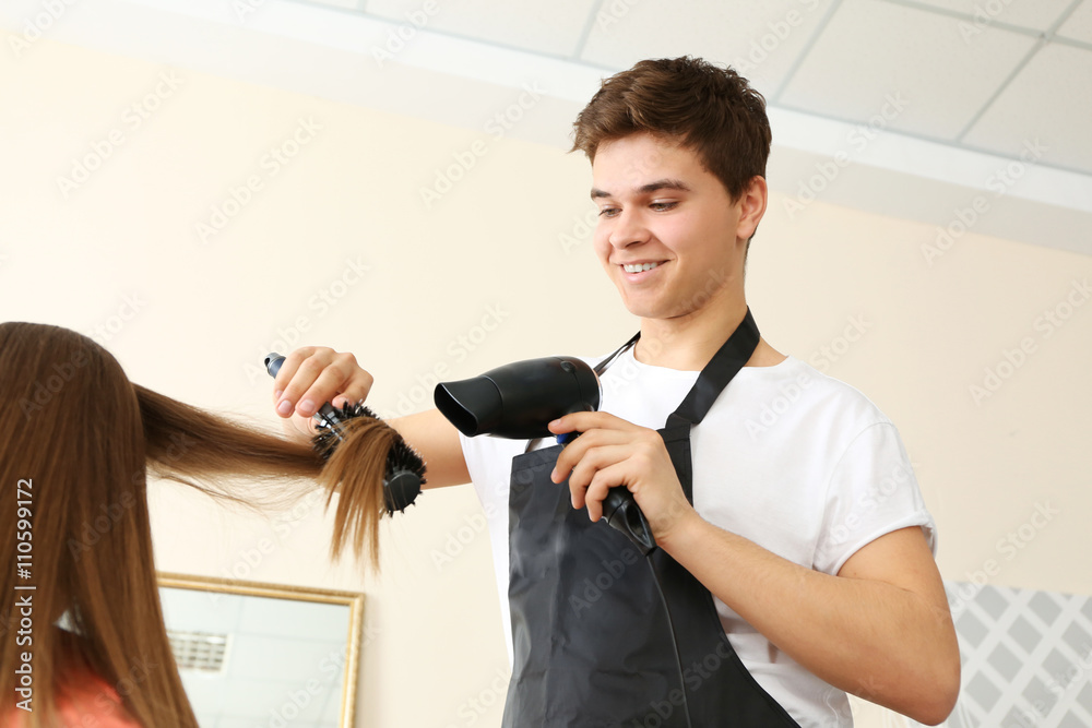 Professional hairdresser drying hair