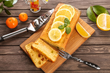 Sticker - Delicious citrus cake loaf with lemons on wooden board