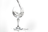 Fototapeta  - Pouring water on a glass on white background