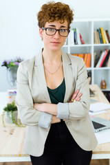 Successful business woman looking at camera in the office.