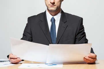 businessman comparing two documents