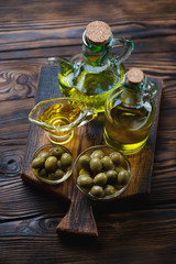 Wall Mural - Still life with olive oil and green olives, studio shot, closeup