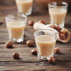 Wall Mural - Traditional Italian hazelnut liqueur on the wooden table