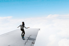 Girl Sakting On Airplane Wing