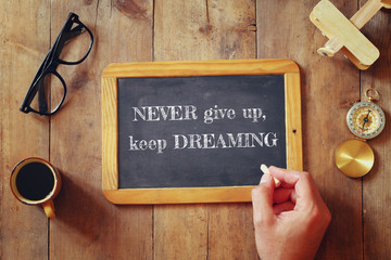 Wall Mural - man writes a phrase: NEVER GIVE UP, KEEP DREAMING