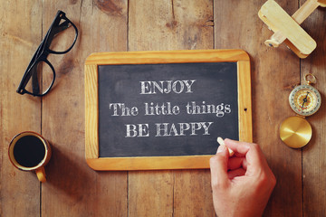 Wall Mural - man writes a phrase: ENJOY THE LITTLE THINGS, BE HAPPY