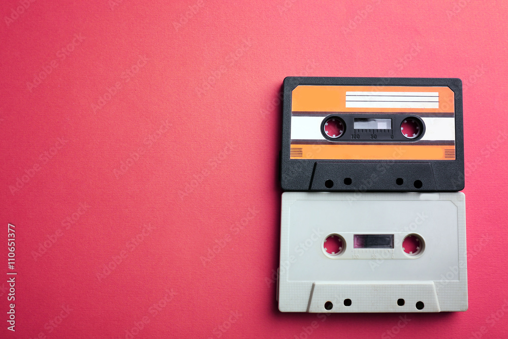 Old audio cassettes on red background
