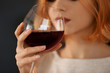 Young woman with glass of red wine closeup