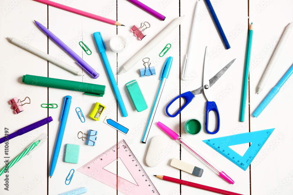 Flat lay of stationery on white wooden table background